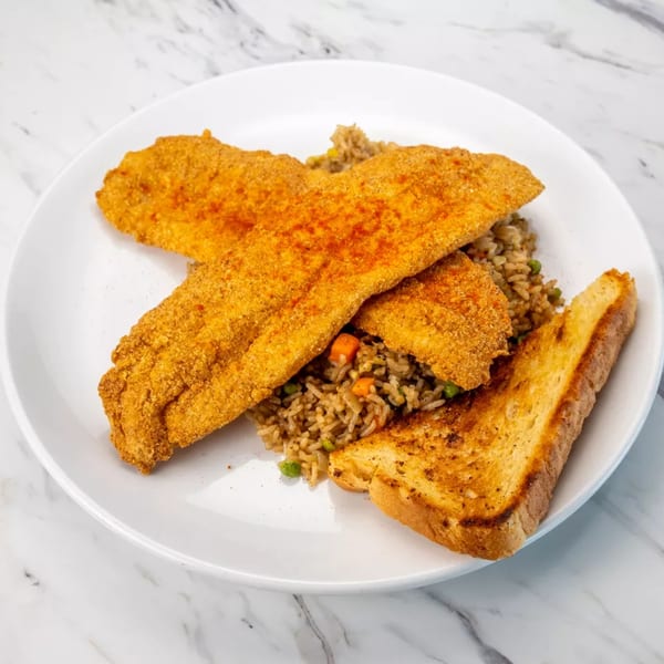 Crispy fried fish fillets with seasoned rice and toasted bread on a white plate.